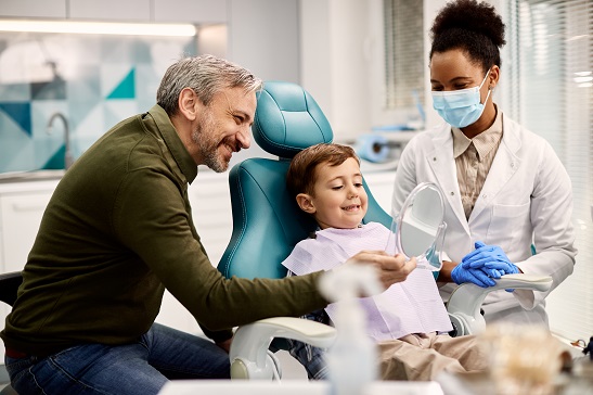 boy at dentist's office with father